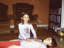 Amba gives Reiki to big sister Jade. Amba and Jade