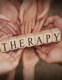 Many diverse hands reaching inward to support wooden blocks that spell out the word "THERAPY."