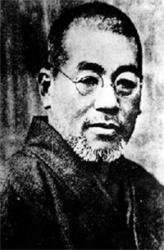 Black-and-white portrait of Usui-Sensei with glasses, short hair, and a trimmed beard, wearing traditional clothing.