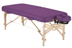 Portable massage table with a purple padded top and wooden frame, featuring an adjustable face cradle on one end.