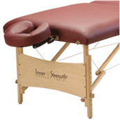 Portable massage table with a padded maroon top, wooden legs, and an adjustable face cradle.