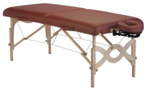 Portable massage table with a burgundy padded top and wooden frame, featuring an adjustable face cradle on one end.