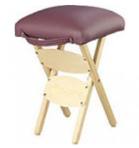Folding wooden stool with a padded maroon seat and built-in carry handle, designed for portable use.